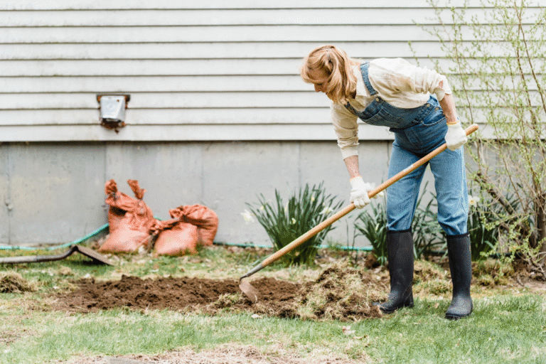 Homeowner doing fall yard work in preparation for spring