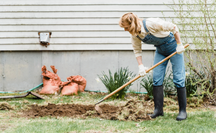 Homeowner doing fall yard work in preparation for spring